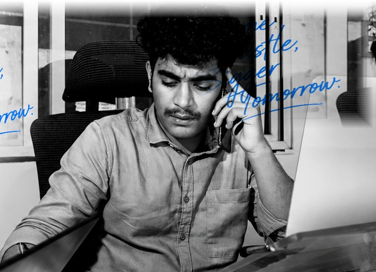 HEXNS authentic first office photograph showing founder working late at desk with laptop and phone